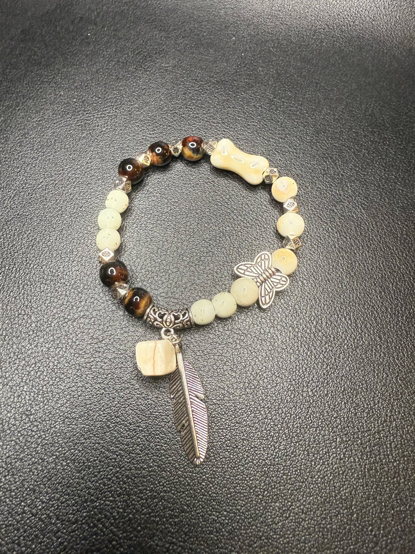 Handcrafted ceramic and glass beads with feather
