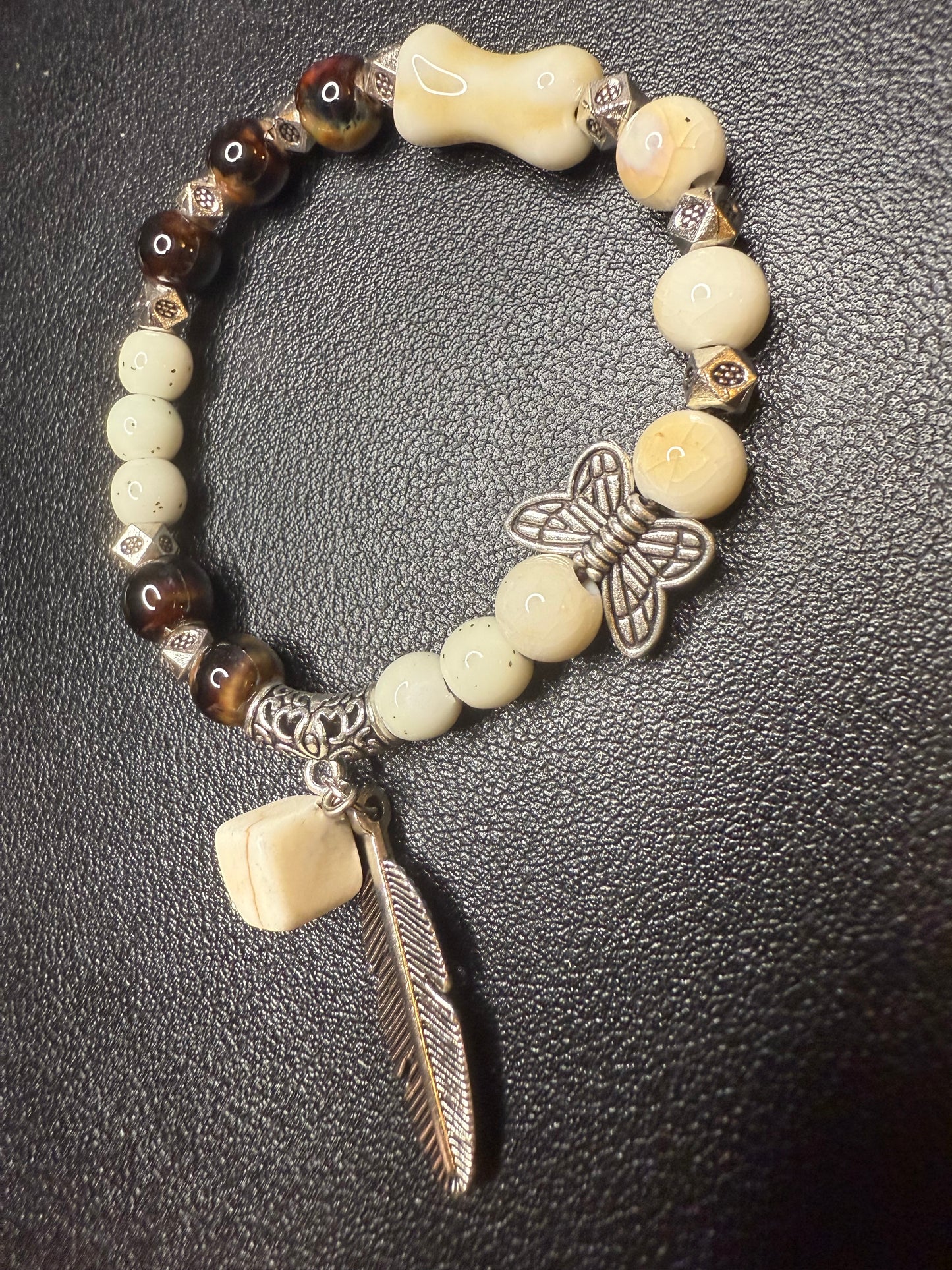 Handcrafted ceramic and glass beads with feather