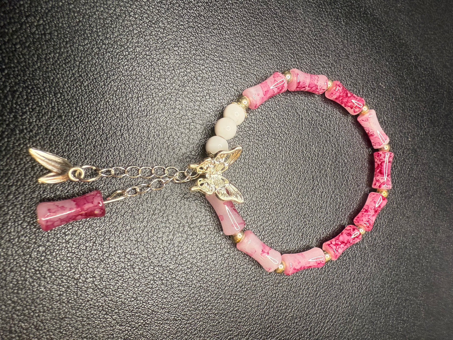 Handcrafted pink beaded bracelet with butterfly