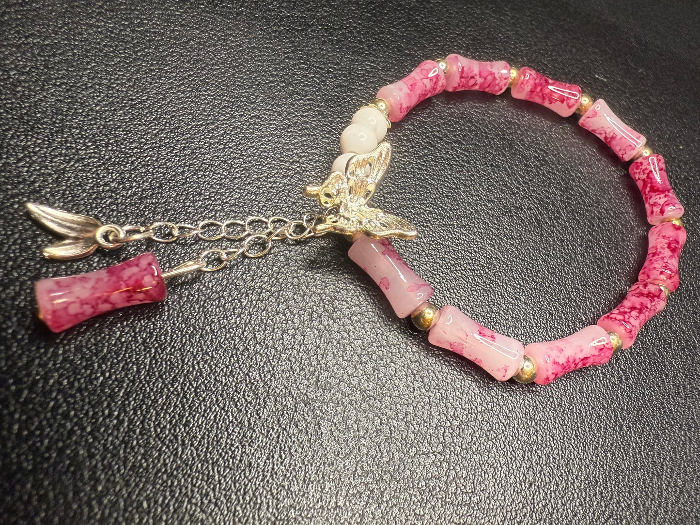Handcrafted pink beaded bracelet with butterfly