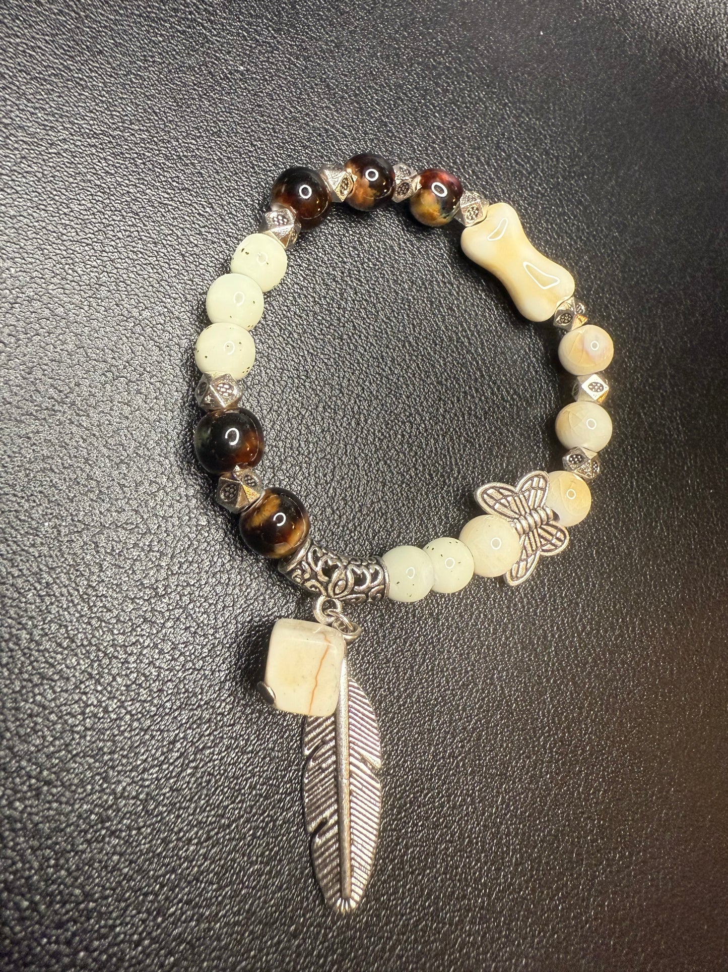 Handcrafted ceramic and glass beads with feather