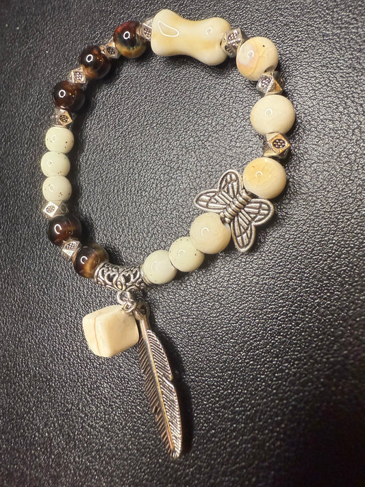 Handcrafted ceramic and glass beads with feather
