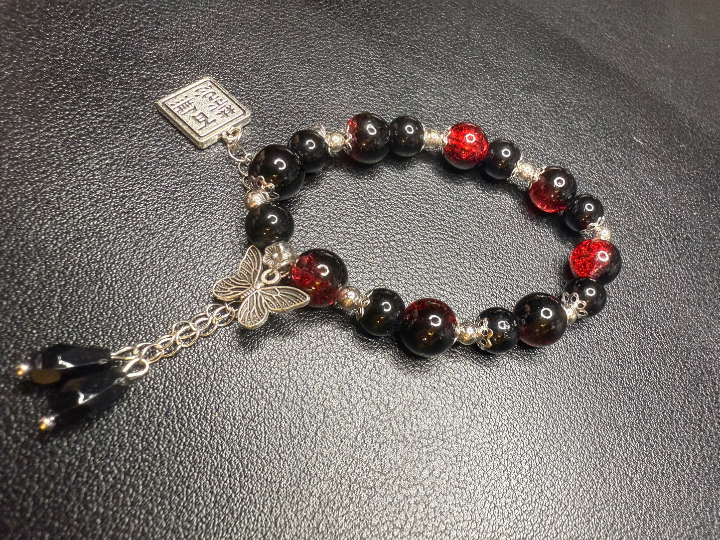 Red glass bead bracelet with metal accents